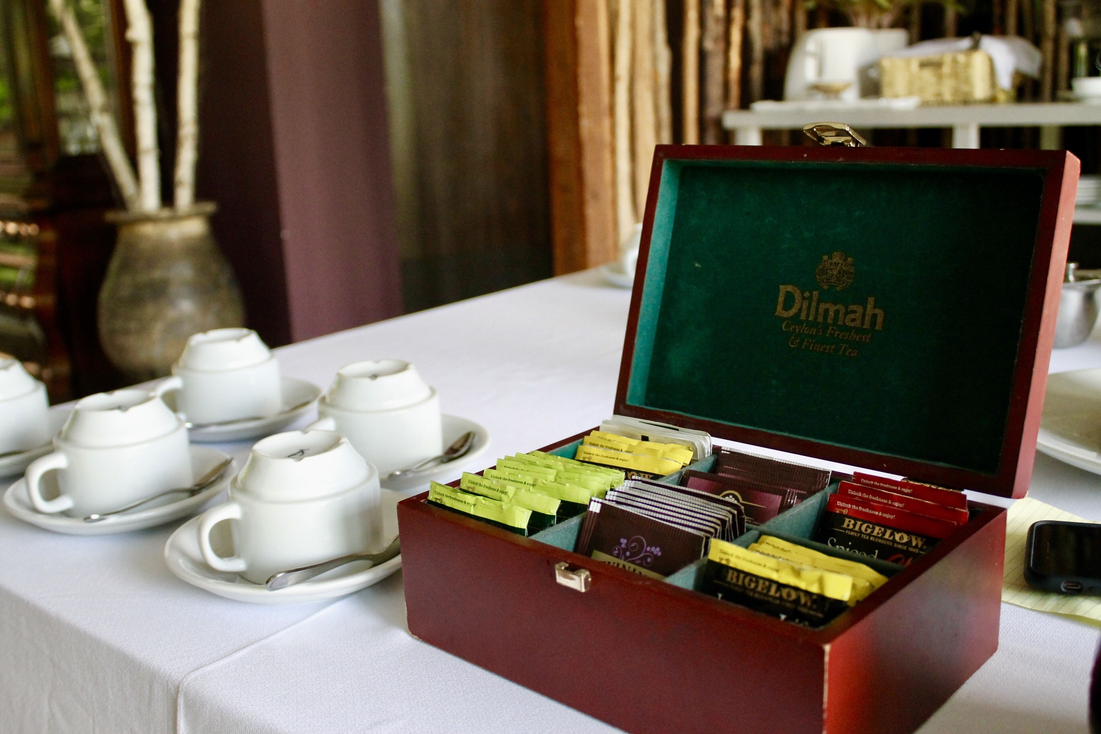 A tea service set with a box of tea bags and a tea set on a table.