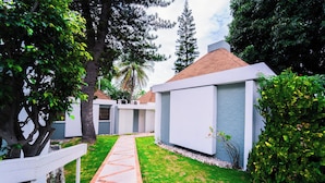 A modern building with a paved pathway leading to the entrance. - Visa Lodge (Port-au-Prince)