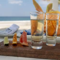 Enjoy a casual beachside meal with a view, featuring a selection of fresh food and refreshing drinks.