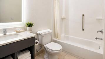 A bathroom with a toilet, sink, and bathtub.