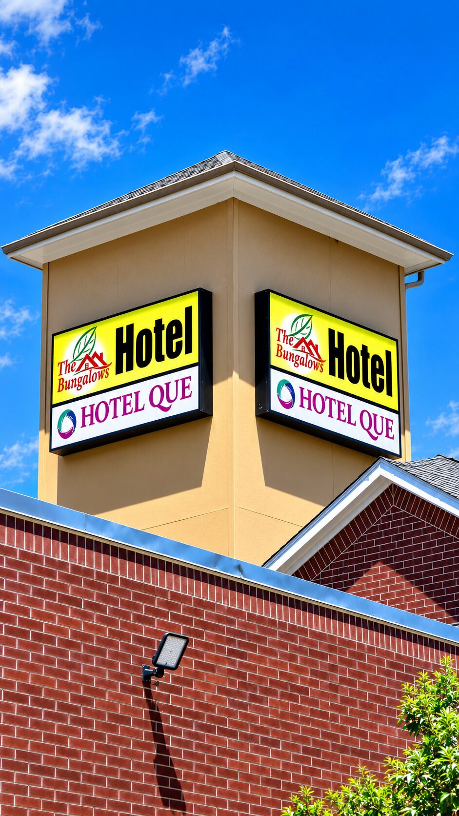 A hotel with two signs, each displaying the hotel's name and logo.