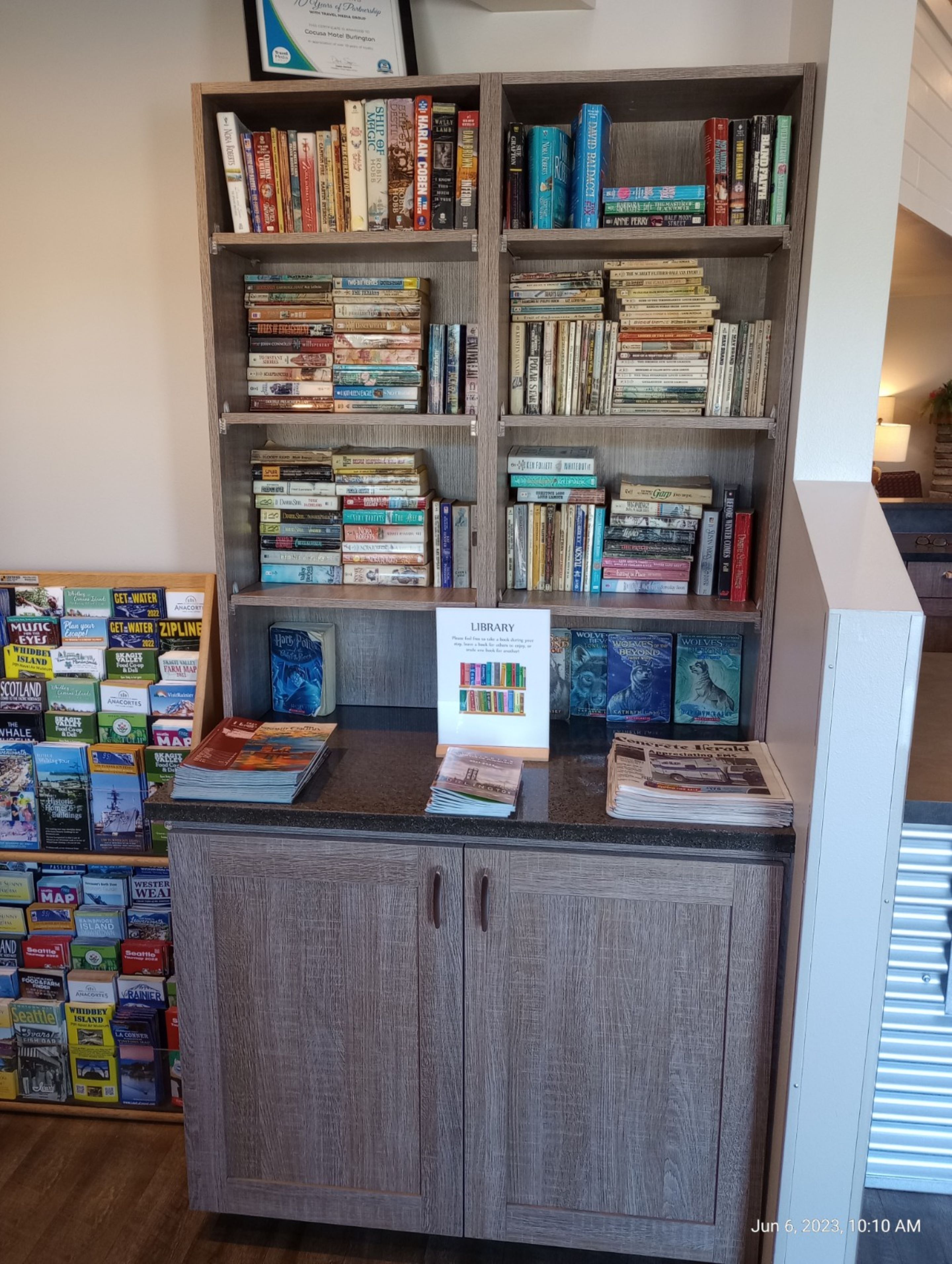 A library with bookshelves filled with various books and a sign indicating the library section.
