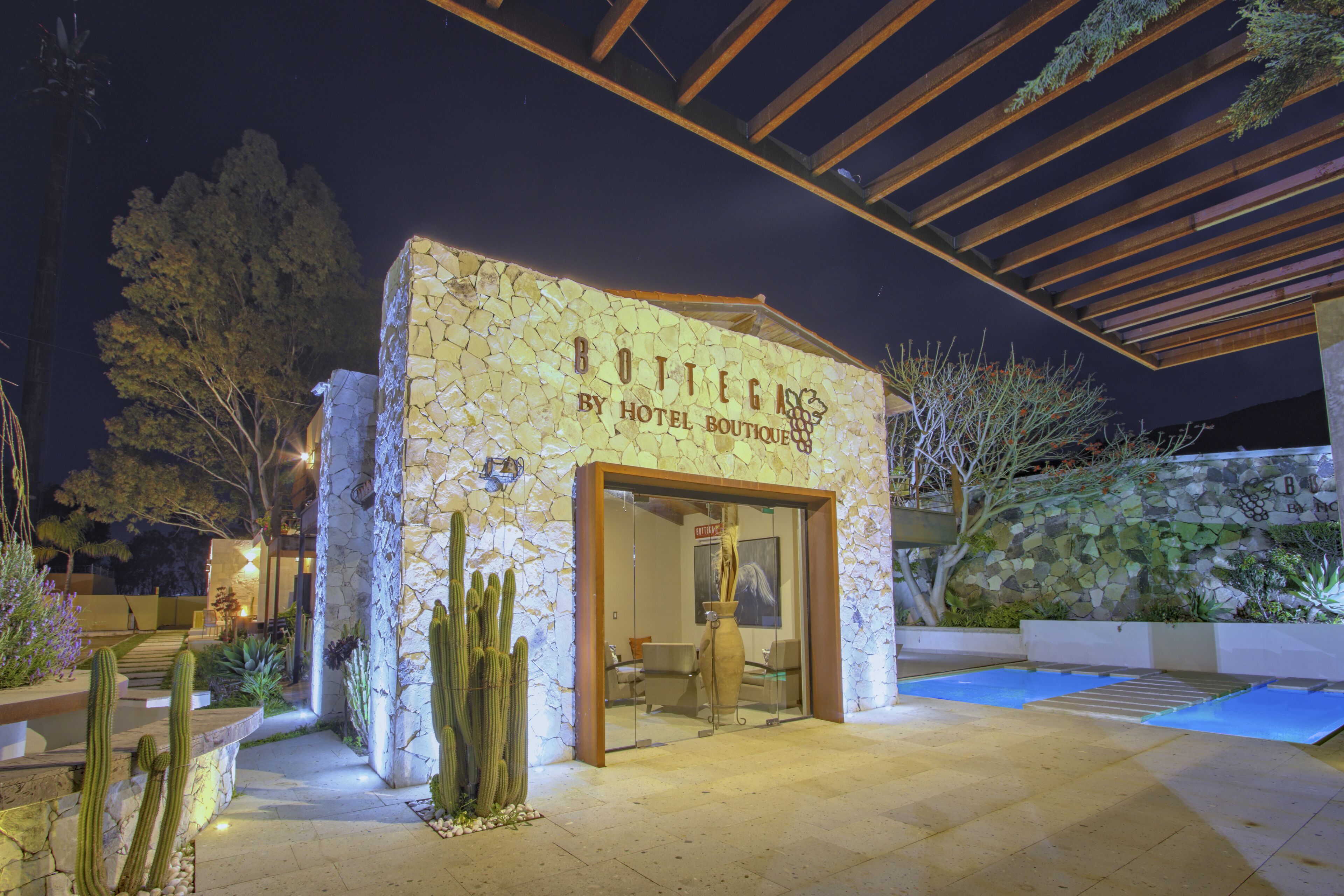 A stone building with a sign reading "Bottega by Hotel Boutique."