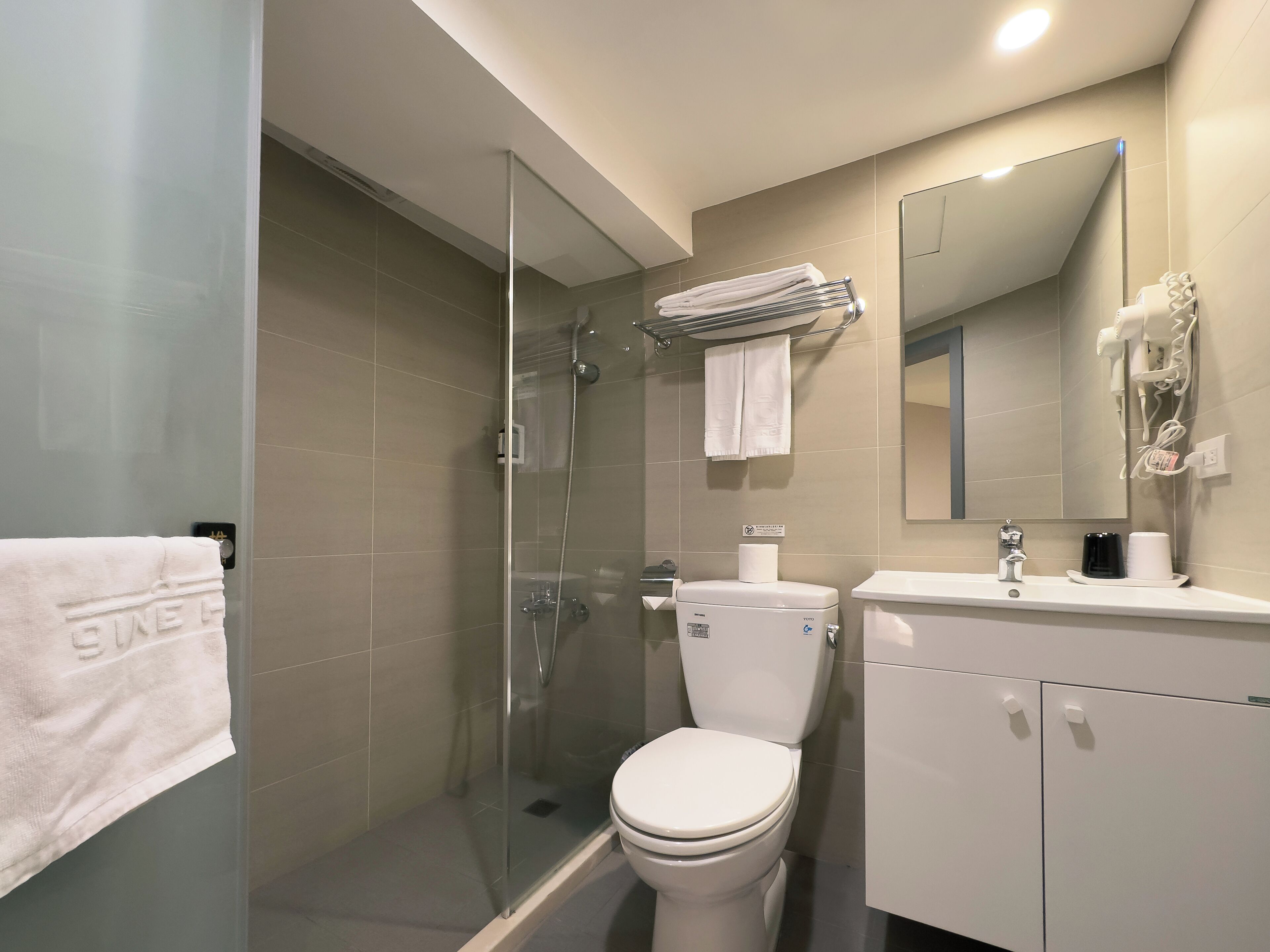 standard twin room | bathroom | shower, rainfall showerhead, hair dryer, towels