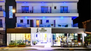A modern hotel with a two-story structure, a visible entrance, and outdoor seating area. - Mikes Kanarium Hotel (Larnaca)