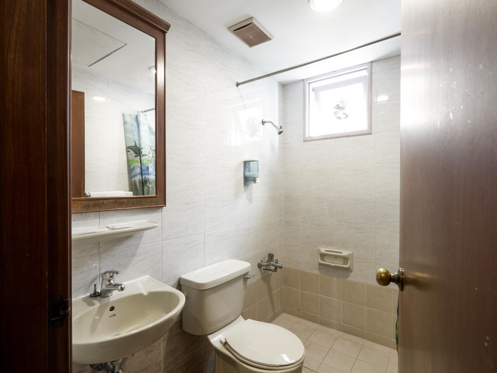 A bathroom with a sink, toilet, and shower.