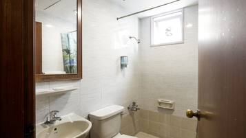 A bathroom with a sink, toilet, and shower.