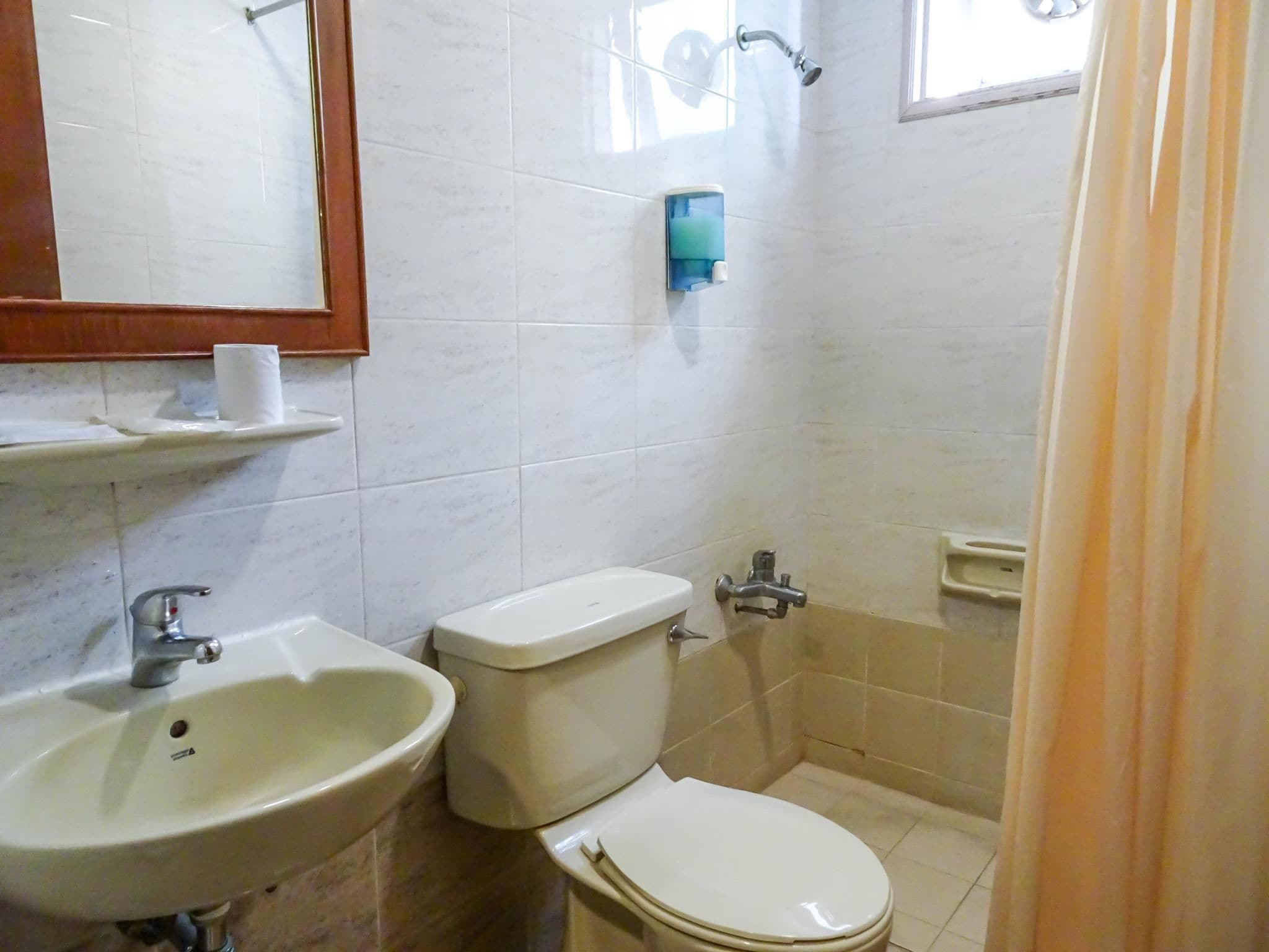 A bathroom with a sink, toilet, and shower.