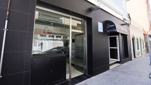 Un bâtiment moderne avec une entrée en verre et une enseigne indiquant « Restaurant La Campana ».