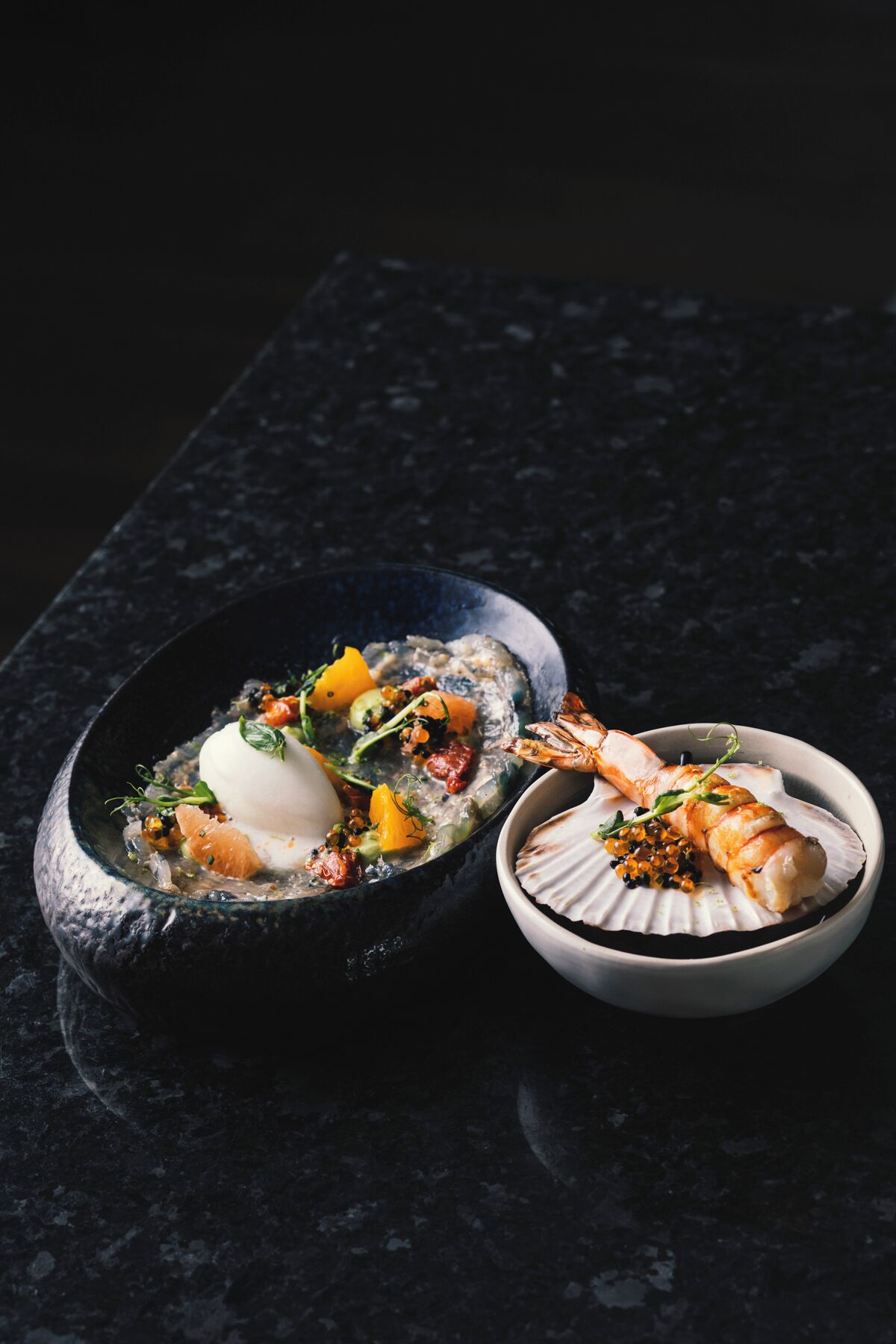 A seafood dish with a scallop and shrimp, served in a bowl.