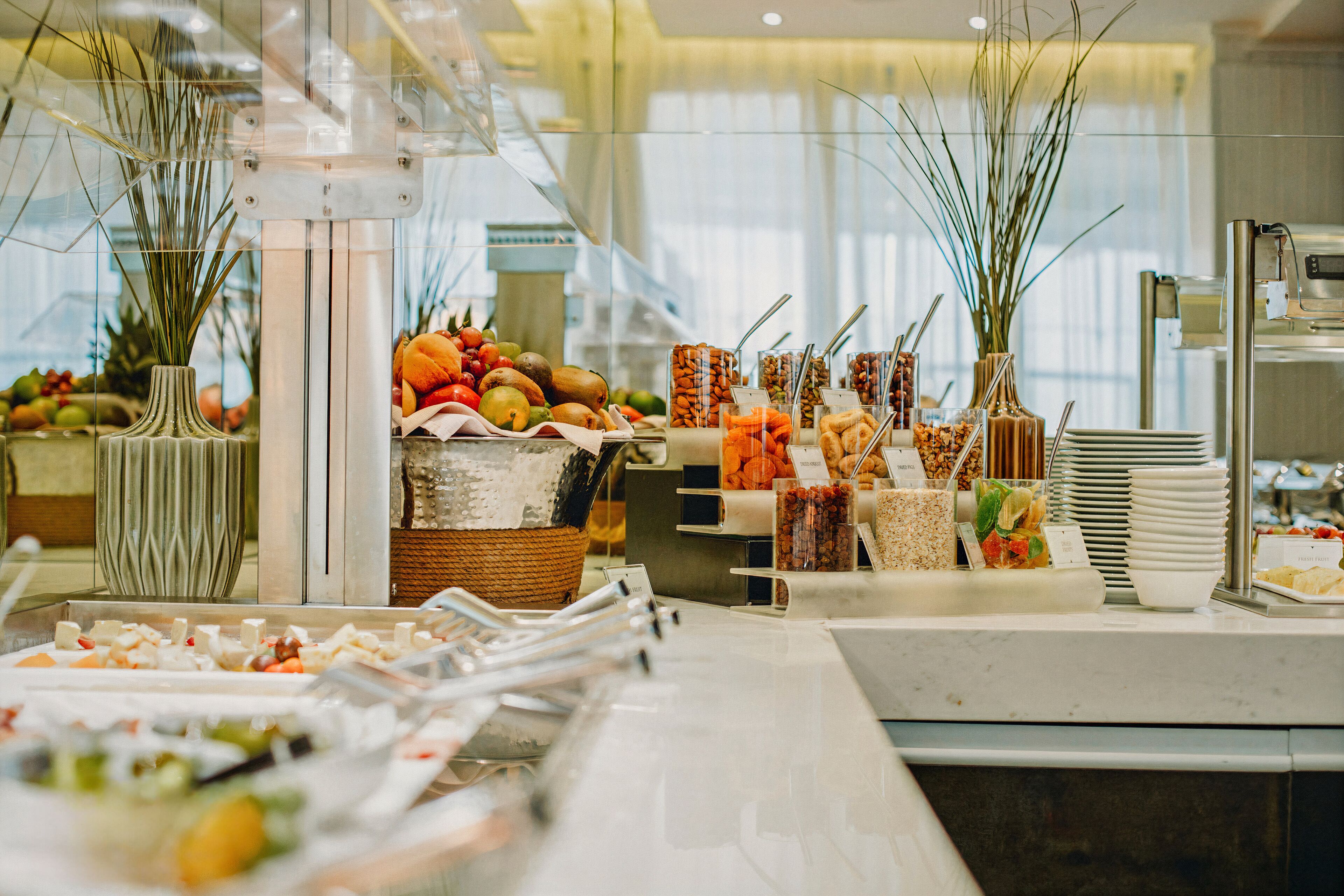 A buffet with various food items and a decorative vase.