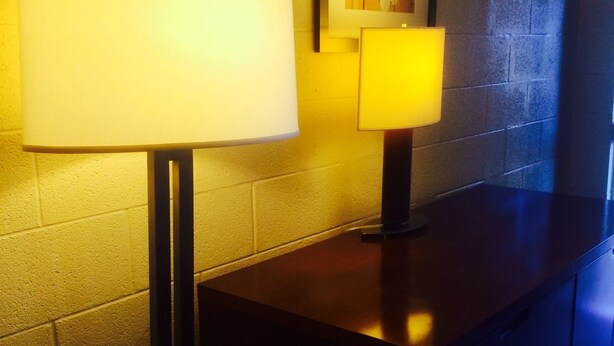 A corner with a wall-mounted lamp and a framed picture. - Stardust Motel and Suites El Dorado KS (El Dorado)