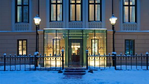 A large, classical building with a symmetrical facade, multiple windows, and a central entrance with glass doors. - Hotel Villa Anna (Uppsala)
