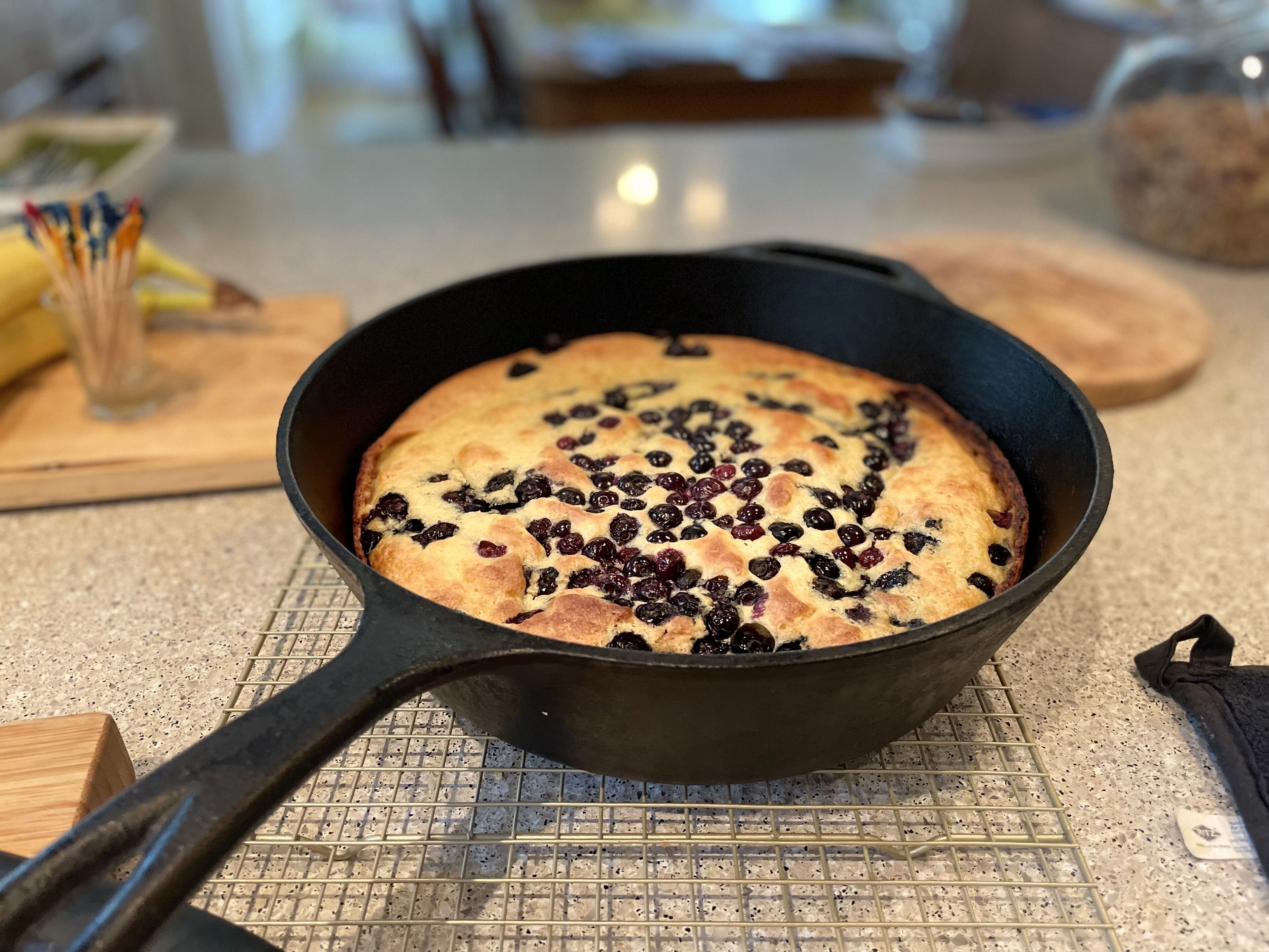 A skillet with a baked dish on a kitchen counter.