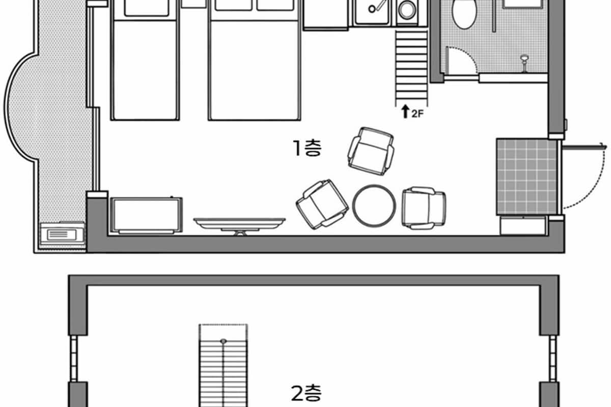 A floor plan of a hotel room with a bed, a desk, a chair, a small table, a sofa, a window, and a bathroom.