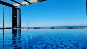 Indoor pool, seasonal outdoor pool, pool umbrellas, sun loungers
