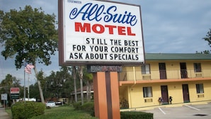 A motel sign with the name 'All Suite Motel' and a message about comfort and specials. - All Suite Motel (Edgewater)