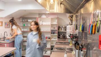 A kitchen with stainless steel appliances, a sink, and a countertop with food items.