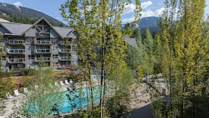 A hotel with a pool, surrounded by trees and mountains. - The Aspens by Whistler Premier (Whistler)