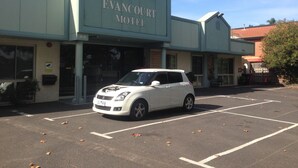 A motel with a white car parked in front. - Evancourt Motel (Malvern East)