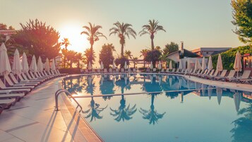 Piscine intérieure, piscine extérieure en saison, parasols