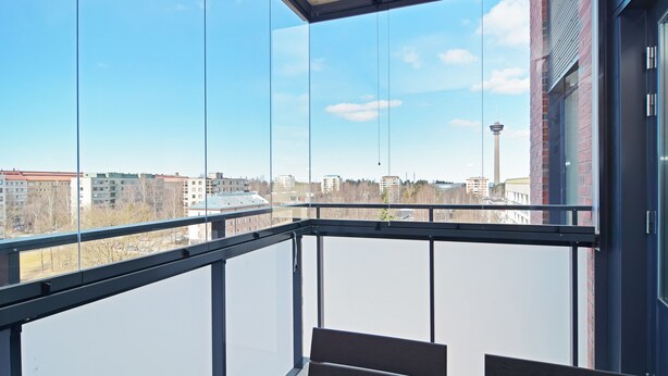 A balcony with a view of a cityscape, including a tower. - Forenom Serviced Apartments Tampere Pyynikki (Tampere)