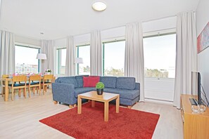 Apartment, 1 Bedroom, Sauna | Living room | Flat-screen TV