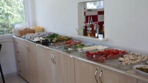 A buffet setup with various food items and condiments. - The Green Valley Hotel (Fethiye)