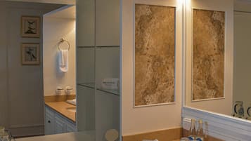 A modern bathroom with a double sink, vanity, and a large mirror.