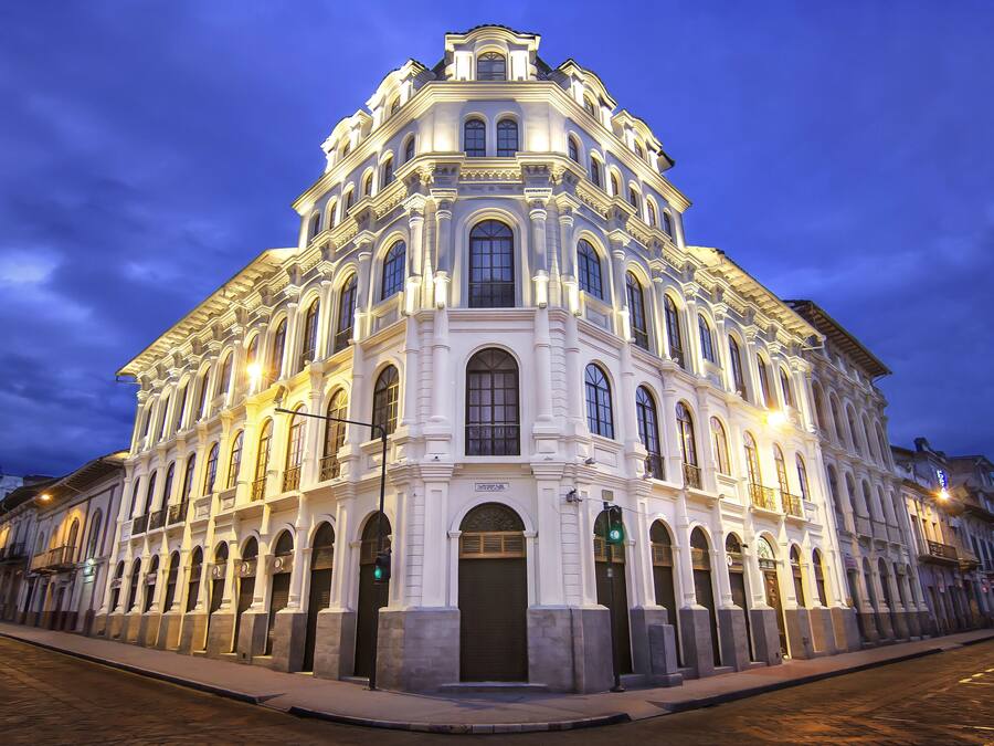 A historic building with a symmetrical facade, large windows, and a central entrance.