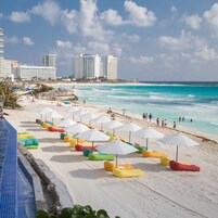 On the beach, white sand, sun loungers, beach umbrellas