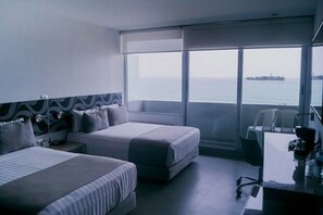 Enjoy a sea view from the large window, with two single beds and a convenient desk area.