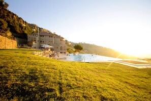 Seasonal outdoor pool, an infinity pool, pool umbrellas, sun loungers