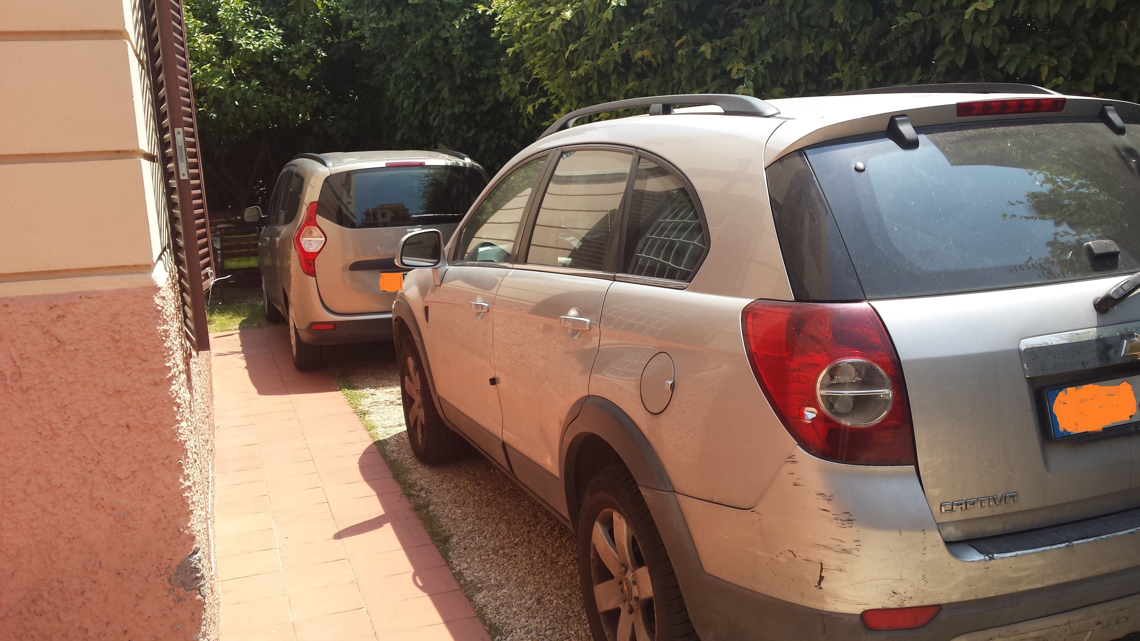 A parking area with two cars parked side by side.