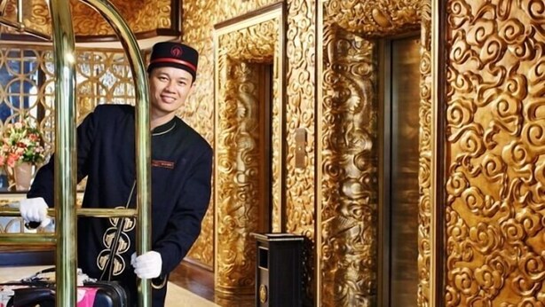 A hotel lobby with ornate golden walls and a reception area. - Hoa Lu Hotel 2 (Ninh Binh)
