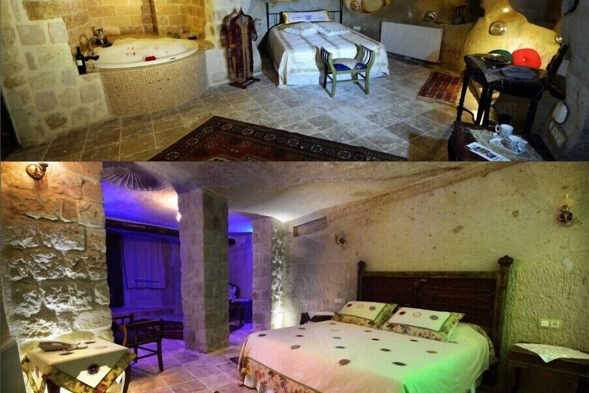 Ein Zimmer mit einer Steinsäule, einem Bett mit grüner Bettdecke, einem Holzstuhl, einem Tisch mit weißer Tischdecke und einem an der Wand hängenden Bild.