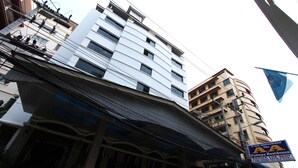 A multi-story building with a sign indicating it is a Pattaya residence.