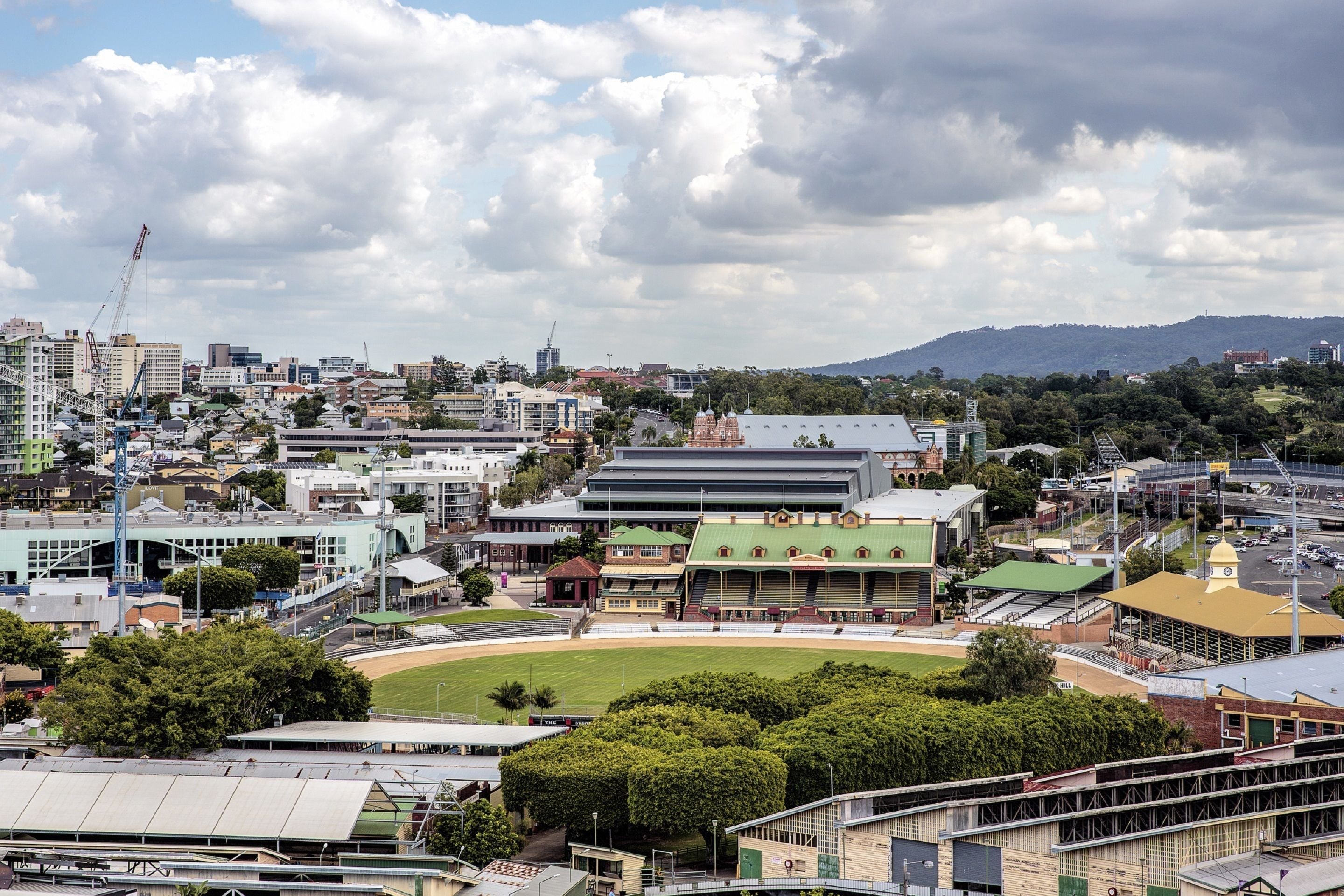 Un estadio con un campo de béisbol rodeado de edificios y árboles.
