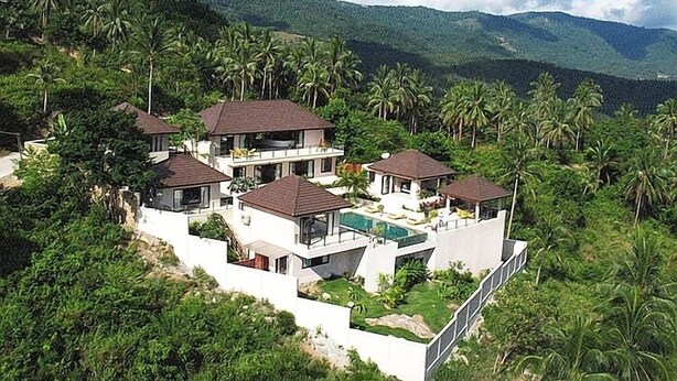 A modern multi-story house with a swimming pool, surrounded by lush greenery and palm trees. - Baan Napoli Luxury Villa (Koh Samui)