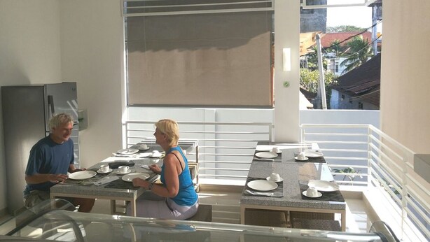 Una cocina moderna con comedor, ventanas amplias y vistas al vecindario.