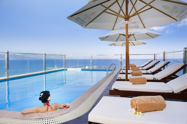 Outdoor pool, a rooftop pool, pool umbrellas, pool loungers