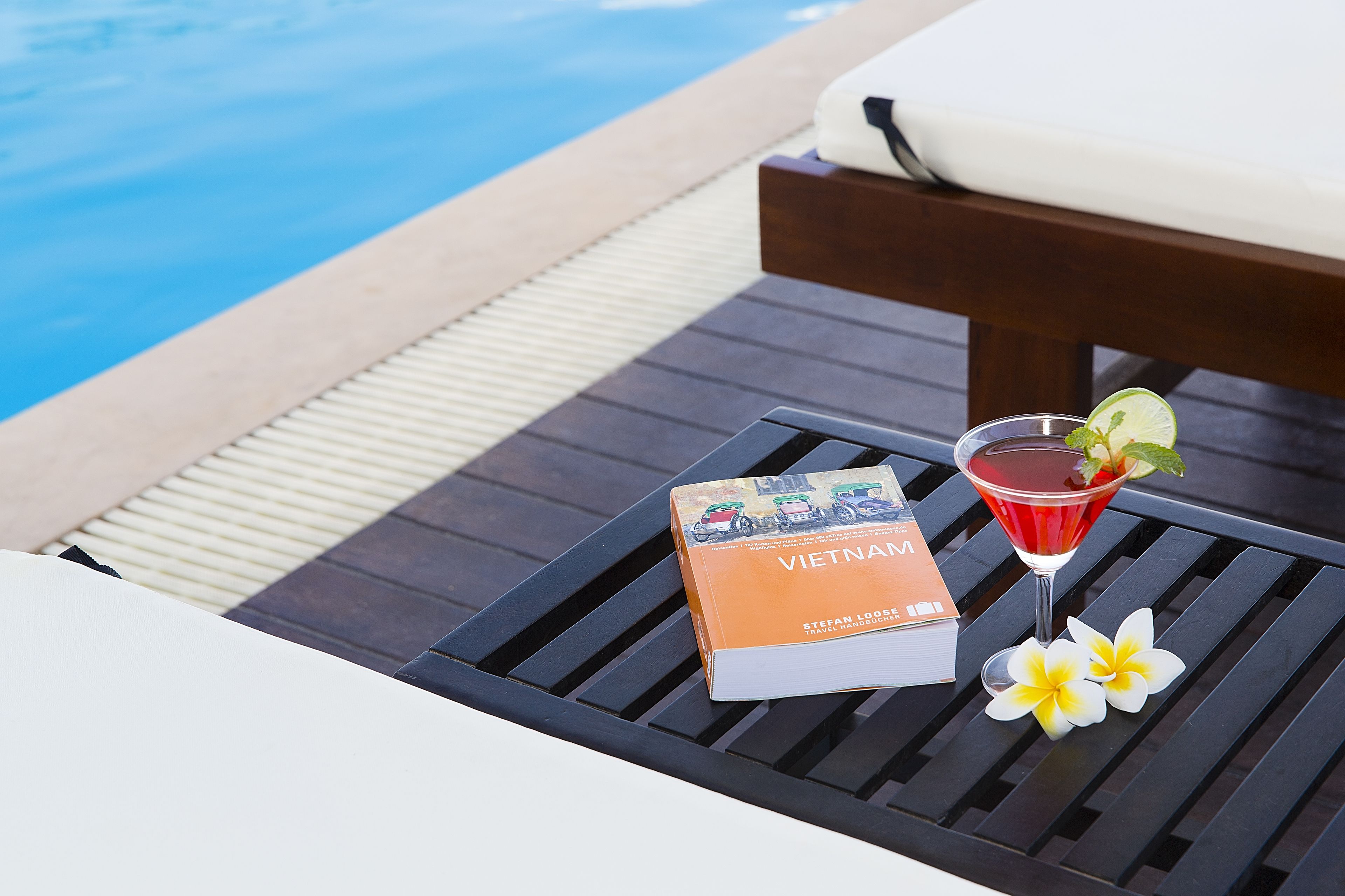 outdoor pool, a rooftop pool, pool umbrellas, pool loungers