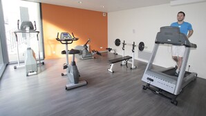 A gym with treadmills, a stationary bike, and a weight bench.