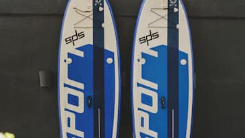 Two surfboards leaning against a wall.