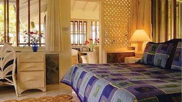 A bedroom with a bed, a desk, and a chair.