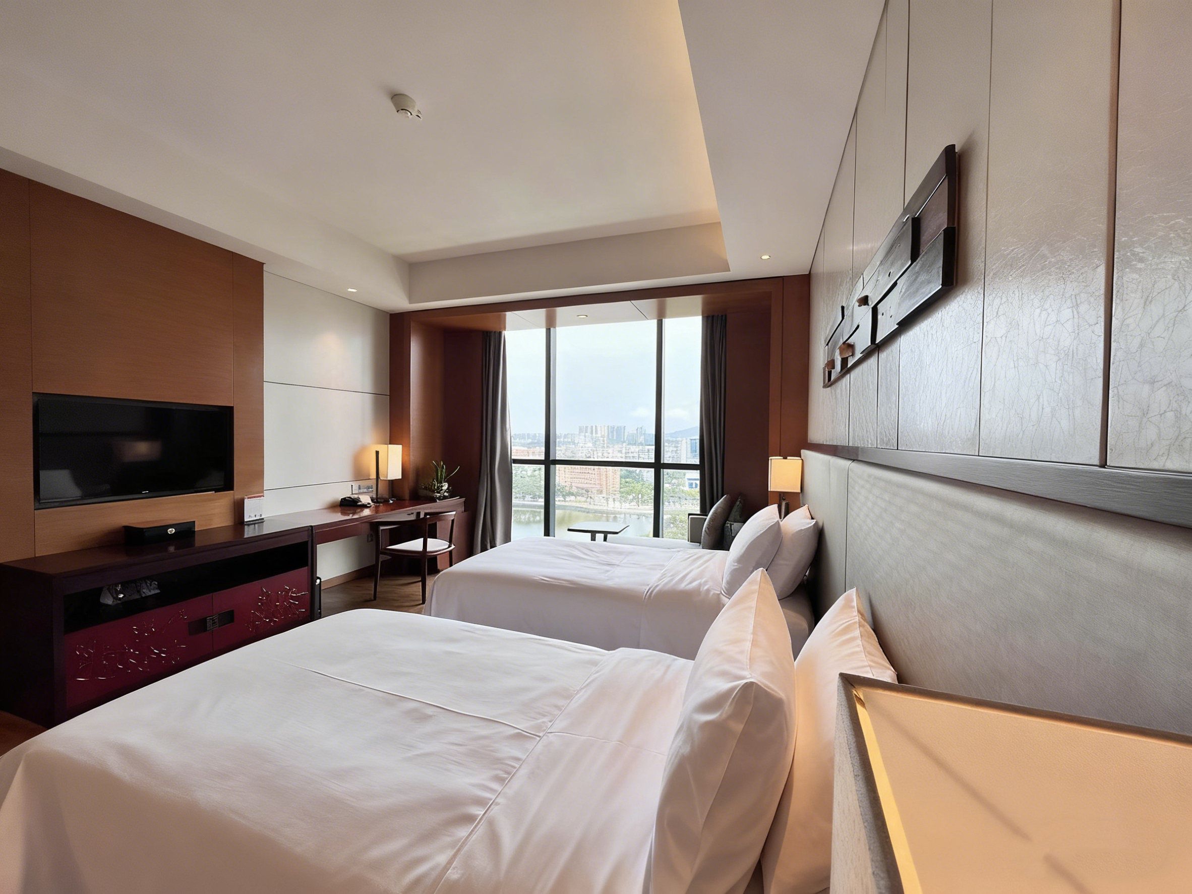 A hotel room with two beds, a desk, a television, and a large window.