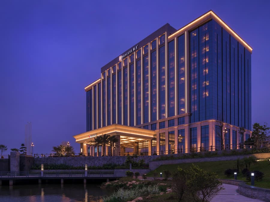 A modern hotel with a prominent entrance and a large glass facade.