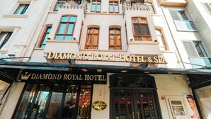 The exterior of the Diamond Royal Hotel & Spa, featuring a classic architectural style with a prominent entrance, outdoor seating area, and a well-maintained facade. - Diamond Royal Hotel (Istanbul)