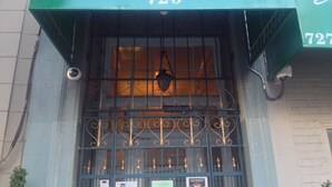 The exterior of Luz Hotel with a green awning displaying the name and address. - Luz Hotel (San Francisco)