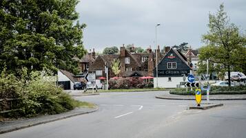 A road leading to a building with a sign reading "The Crown Inn."